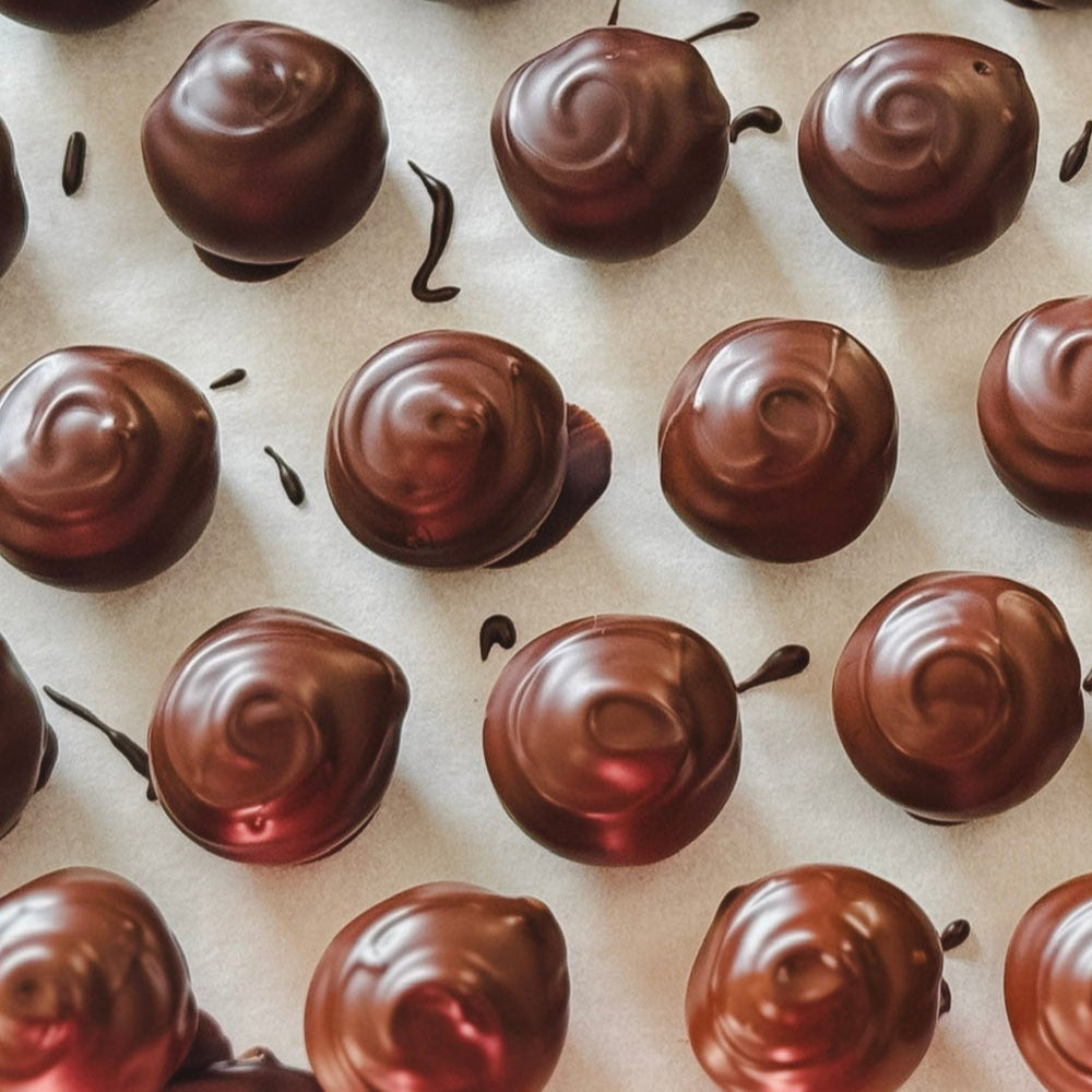 Making chocolate-coated caramels on a kitchen surface